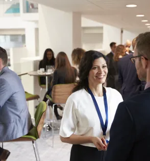 Conference guests chatting in a bright lobby