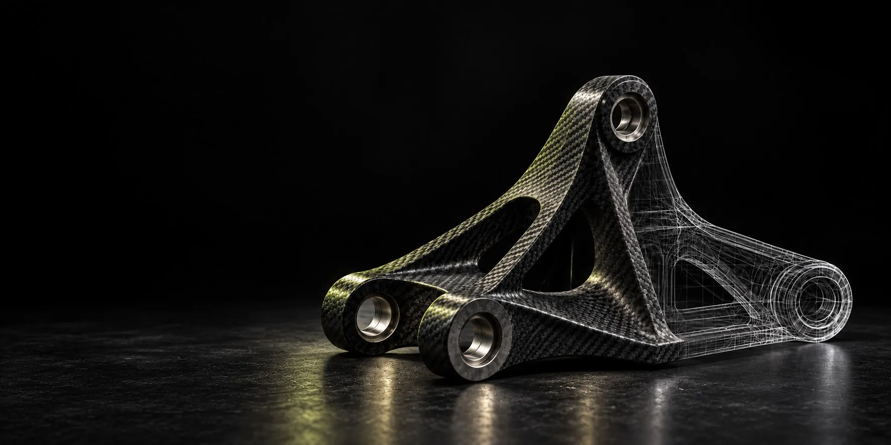 Carbon fiber suspension bracket with steel bushings, half shown as an engineering wireframe