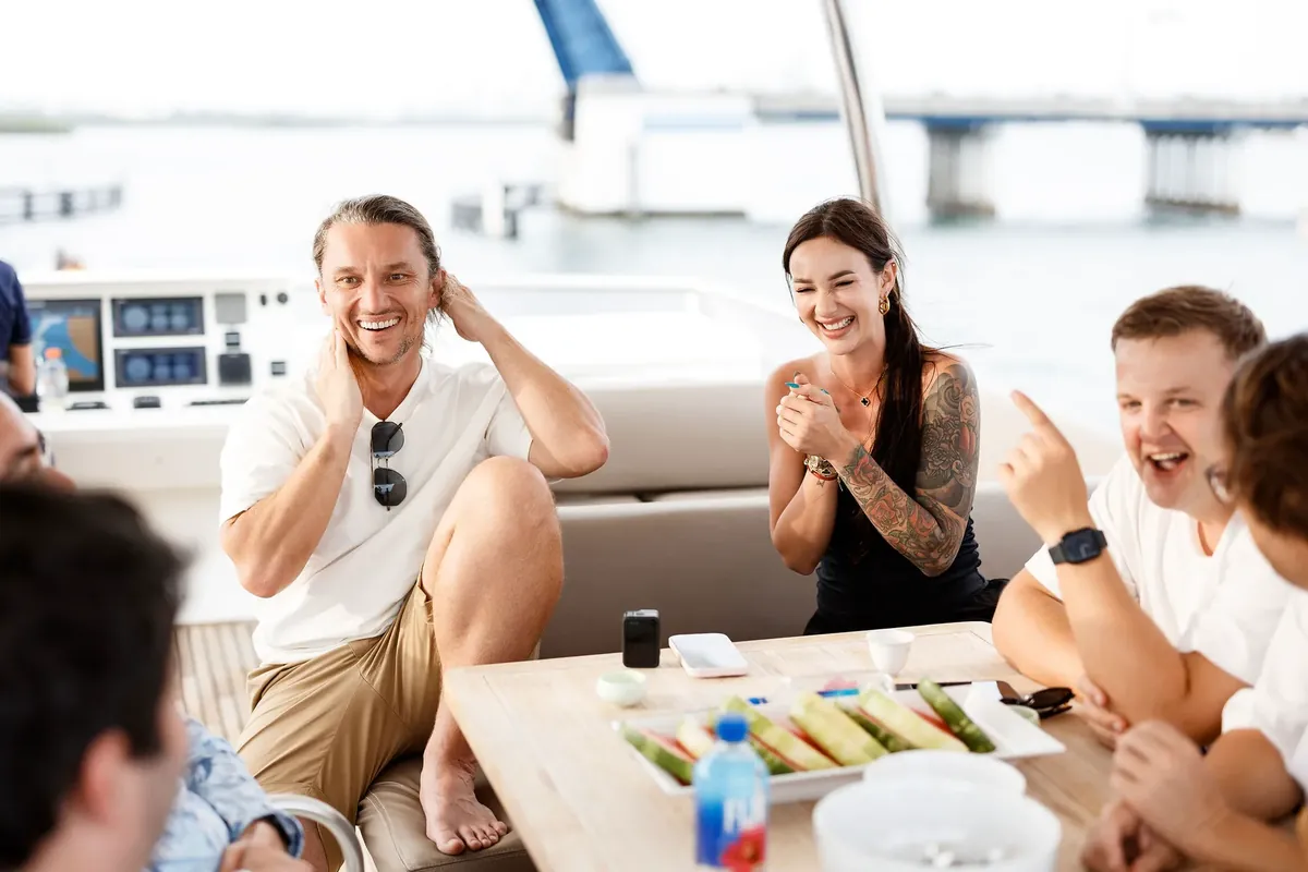 Club members laughing on a yacht