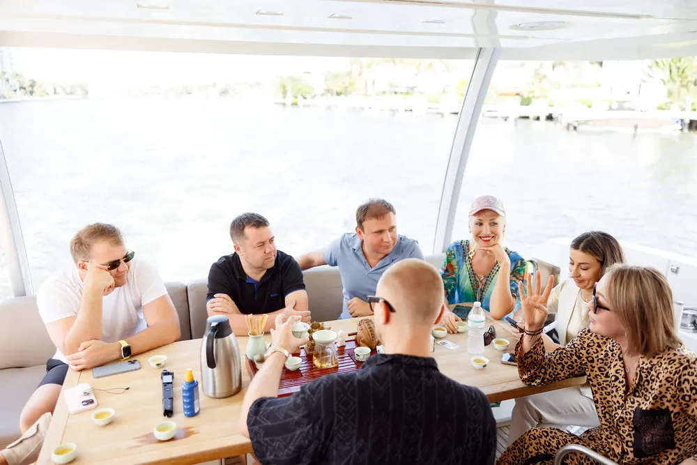Residents at a table on a boat