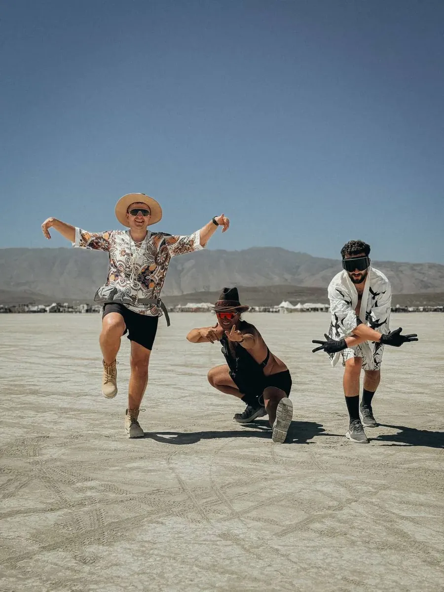 Community members jumping in the desert